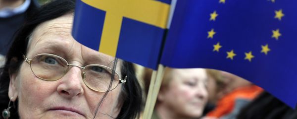 A woman holding a European flag and a Swedish flag A woman holding a European flag and a Swedish flag - Sputnik International