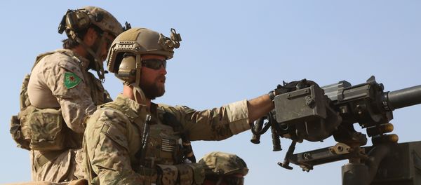Armed men in uniform identified by Syrian Democratic forces as US special operations forces ride in the back of a pickup truck in the village of Fatisah in the northern Syrian province of Raqa on May 25, 2016 - Sputnik International