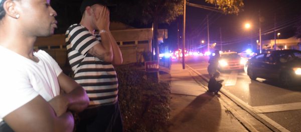 Jermaine Towns, left, and Brandon Shuford wait down the street from a multiple shooting at a nightclub in Orlando, Fla., Sunday, June 12, 2016 - Sputnik International