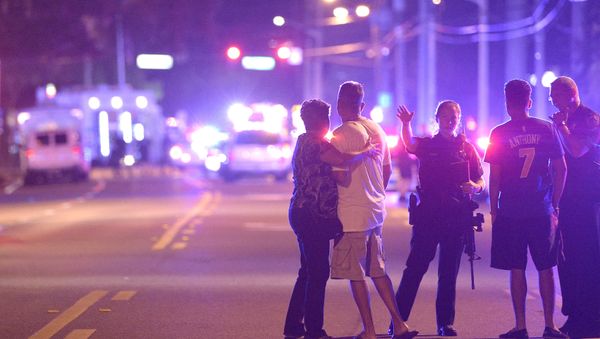 Orlando Police officers direct family members away from a multiple shooting at a nightclub in Orlando, Fla., Sunday, June 12, 2016 Orlando Police officers direct family members away from a multiple shooting at a nightclub in Orlando, Fla., Sunday, June 12, 2016 - Sputnik International
