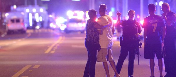 Orlando Police officers direct family members away from a multiple shooting at a nightclub in Orlando, Fla., Sunday, June 12, 2016 - Sputnik International