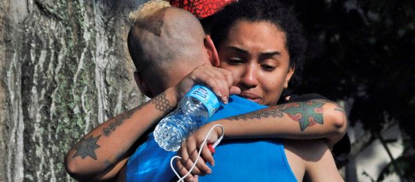 Friends and family members embrace outside the Orlando Police Headquarters during the investigation of a shooting at the Pulse nightclub, where people were killed by a gunman, in Orlando, Florida, U.S June 12, 2016 Friends and family members embrace outside the Orlando Police Headquarters during the investigation of a shooting at the Pulse nightclub, where people were killed by a gunman, in Orlando, Florida, U.S June 12, 2016 - Sputnik International