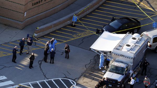 Officials are on the scene outside of Sandy Hook Elementary School in Newtown, Conn., where authorities say a gunman opened fire inside an elementary school in a shooting that left 27 people dead, including 20 children, Friday, Dec. 14, 2012 - Sputnik International