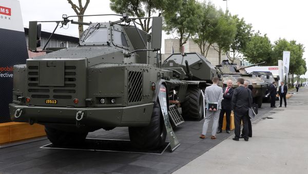 People look at military vehicles displayed on June 13, 2016 during the the Eurosatory defence and security international exhibition in Villepinte, near Paris. - Sputnik International