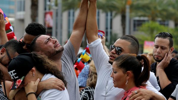 Mourners grieve at a vigil for the victims of the shooting at the Pulse gay nightclub in Orlando, Florida, June 13, 2016. - Sputnik International