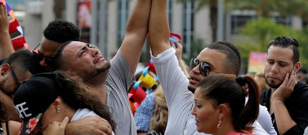 Mourners grieve at a vigil for the victims of the shooting at the Pulse gay nightclub in Orlando, Florida, June 13, 2016. - Sputnik International