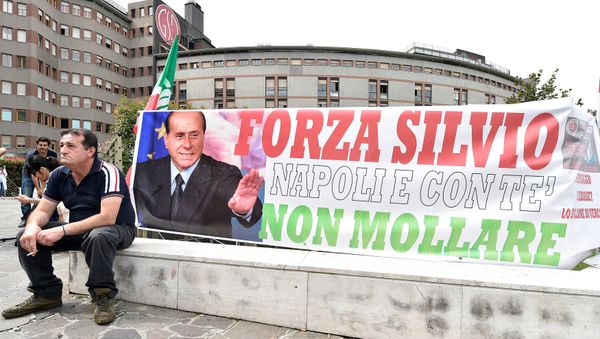A man sits next to a banner reading Come on Silvio, Naples is with you, never give up in front of San Raffaele hospital, as Italian surgeons begin a four-hour heart operation on former prime minister Silvio Berlusconi on Tuesday to replace a defective aortic valve, a hospital statement said, in Milan, Italy June 14, 2016. A man sits next to a banner reading Come on Silvio, Naples is with you, never give up in front of San Raffaele hospital, as Italian surgeons begin a four-hour heart operation on former prime minister Silvio Berlusconi on Tuesday to replace a defective aortic valve, a hospital statement said, in Milan, Italy June 14, 2016. - Sputnik International