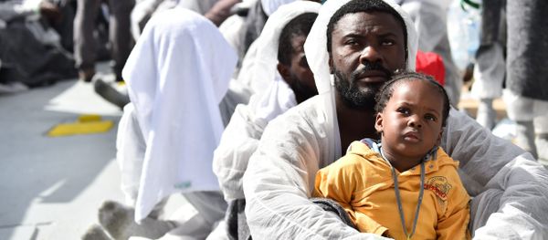 A man and his daughter wait during a distribution of meals aboard the rescue ship Aquarius, on May 25, 2016 a day after a rescue operation of migrants and refugees off the Libyan coast. A man and his daughter wait during a distribution of meals aboard the rescue ship Aquarius, on May 25, 2016 a day after a rescue operation of migrants and refugees off the Libyan coast. - Sputnik International