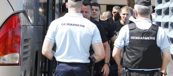 Repeating with additional information for clarification - Russian soccer fans (seen at center rear), suspected of being involved in clashes, are ushered off their bus after being stopped by gendarmes in Mandelieu near Cannes in southern France, June 14, 2016 - Sputnik International