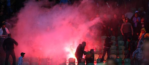 Flares are thrown in the stadium during clashes that erupted after a football match between Egypt's Al-Ahly and Al-Masry teams in Port Said, 220 kms northeast of Cairo. (File) Flares are thrown in the stadium during clashes that erupted after a football match between Egypt's Al-Ahly and Al-Masry teams in Port Said, 220 kms northeast of Cairo. (File) - Sputnik International