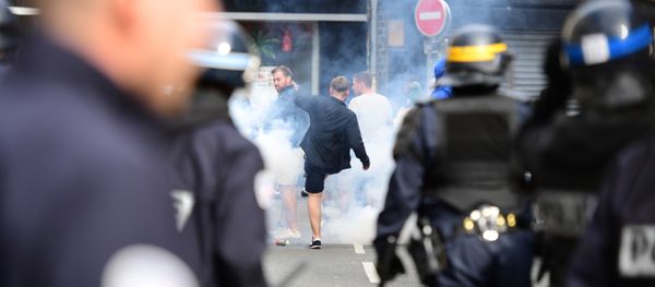 French policemen fire tear gas to disperse supporters gathering outside a bar in Lille, northern France - Sputnik International