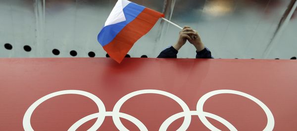 In this Feb. 18, 2014 file photo, a Russian skating fan holds the country's national flag over the Olympic rings before the start of the men's 10,000-meter speedskating race at Adler Arena Skating Center during the 2014 Winter Olympics in Sochi, Russia In this Feb. 18, 2014 file photo, a Russian skating fan holds the country's national flag over the Olympic rings before the start of the men's 10,000-meter speedskating race at Adler Arena Skating Center during the 2014 Winter Olympics in Sochi, Russia - Sputnik International
