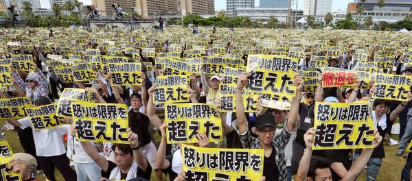 Protesters raise placards reading Anger was over the limit during a rally against the U.S. military presence on the island and a series of crimes and other incidents involving U.S. soldiers and base workers, at a park in the prefectural capital Naha on Japan's southern island of Okinawa, Japan, in this photo taken by Kyodo June 19, 2016 Protesters raise placards reading Anger was over the limit during a rally against the U.S. military presence on the island and a series of crimes and other incidents involving U.S. soldiers and base workers, at a park in the prefectural capital Naha on Japan's southern island of Okinawa, Japan, in this photo taken by Kyodo June 19, 2016 - Sputnik International