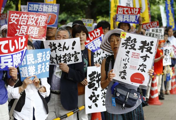 Protesters carry anti-U.S. military placards during a rally in front of the National Diet building in Tokyo Sunday, June 19, 2016 Protesters carry anti-U.S. military placards during a rally in front of the National Diet building in Tokyo Sunday, June 19, 2016 - Sputnik International