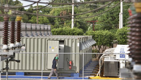 A worker checks an electrical generator from the Petroleos de Venezuela SA, or PVDSA. (File) A worker checks an electrical generator from the Petroleos de Venezuela SA, or PVDSA. (File) - Sputnik International