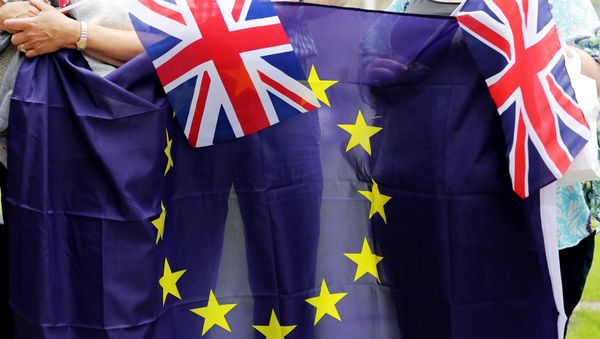 People hold Union Flags and the EU flag at a kiss chain event organised by pro-Europe 'remain' campaigners seeking to avoid a Brexit in the EU referendum in Parliament Square in front of the Houses of Parliament in central London on June 19, 2016. People hold Union Flags and the EU flag at a kiss chain event organised by pro-Europe 'remain' campaigners seeking to avoid a Brexit in the EU referendum in Parliament Square in front of the Houses of Parliament in central London on June 19, 2016. - Sputnik International
