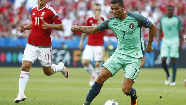 Football Soccer - Hungary v Portugal - EURO 2016 - Group F - Stade de Lyon, Lyon, France - 22/6/16 Portugal's Cristiano Ronaldo in action with Hungary's Krisztian Nemeth Football Soccer - Hungary v Portugal - EURO 2016 - Group F - Stade de Lyon, Lyon, France - 22/6/16 Portugal's Cristiano Ronaldo in action with Hungary's Krisztian Nemeth - Sputnik International
