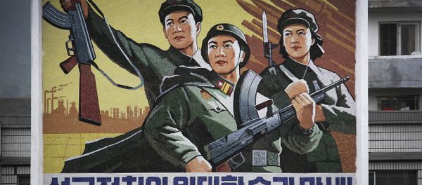 A North Korean man and woman walk under a mural with a message which reads Long live the great victory of the army-first policy in the city center of Wonsan on Wednesday, June 22, 2016, in Wonsan, North Korea. A North Korean man and woman walk under a mural with a message which reads Long live the great victory of the army-first policy in the city center of Wonsan on Wednesday, June 22, 2016, in Wonsan, North Korea. - Sputnik International