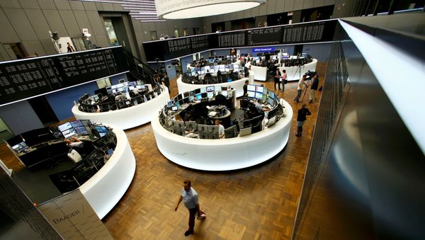 Traders work at their desks in front of the German share price index, DAX board, at the stock exchange in Frankfurt, Germany, June 24, 2016 after Britain voted to leave the European Union in the EU BREXIT referendum. - Sputnik International