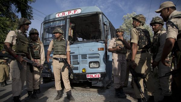 Indian security personnel stand guard near the bus that was carrying paramilitary soldiers damaged after a highway ambush by suspected rebels in Pampore, on the outskirts of Srinagar, Indian controlled Kashmir, Saturday, June 25, 2016 - Sputnik International
