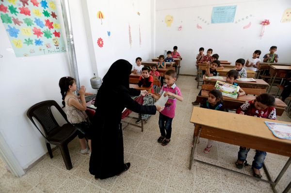 Students receive certificates and gifts at the end of the school year, inside 'Syria, The Hope' school on the outskirts of the rebel-controlled area of Maaret al-Numan town, in Idlib province, Syria June 1, 2016 - Sputnik International