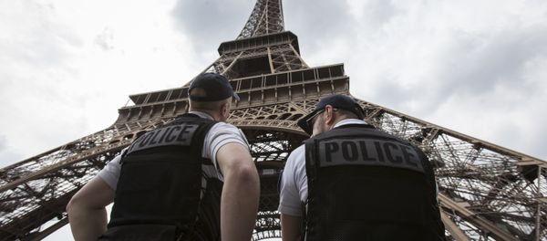 French riot police officers patrol under the Eiffel Tower, near the entrance of the soccer fan zone, prior to the Euro 2016 Group A soccer match between France and Romania, in Paris, Friday, June 10, 2016 - Sputnik International