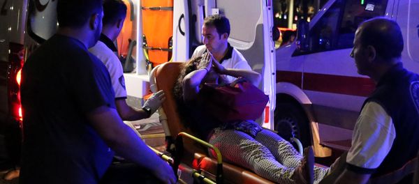An injured woman covers her face as she is carried by paramedics into ambulance at Istanbul Ataturk airport, Turkey, following a blast June 28, 2016. An injured woman covers her face as she is carried by paramedics into ambulance at Istanbul Ataturk airport, Turkey, following a blast June 28, 2016. - Sputnik International