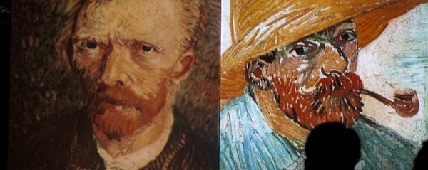 A visitor stands in front of giant screens featuring images of the work of Dutch painter Vincent van Gogh during a traveling multimedia art exhibition entitled Van Gogh alive on February 4, 2013 - Sputnik International