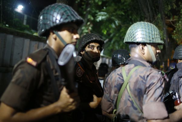Bangladeshi security personnel stand guard near a restaurant that has reportedly been attacked by unidentified gunmen in Dhaka, Bangladesh - Sputnik International