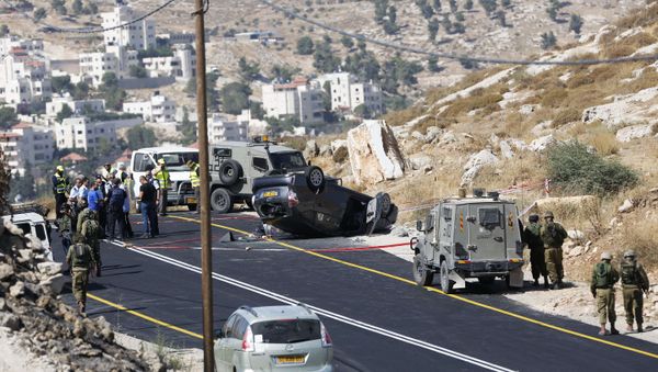Israeli soldiers secure the scene of a shooting attack near Hebron, West Bank, Friday, July 1, 2016 - Sputnik International