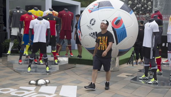 A man walks past a sports clothing promotion for the Euro 2016 tournament at a retail district in Beijing, China, Friday, June 10, 2016 - Sputnik International