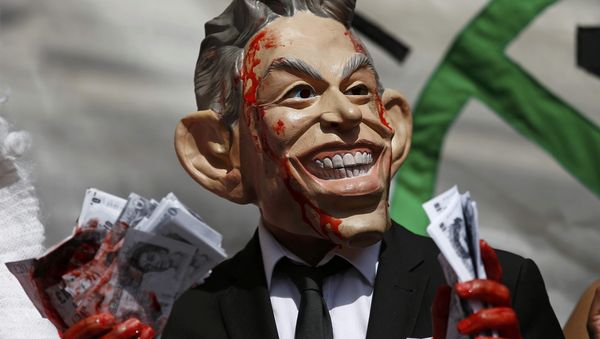 A demonstrator wearing a mask to impersonate Tony Blair holds bundles of fake money during a protest before the release of the John Chilcot report into the Iraq war, at the Queen Elizabeth II centre in London, Britain July 6, 2016 A demonstrator wearing a mask to impersonate Tony Blair holds bundles of fake money during a protest before the release of the John Chilcot report into the Iraq war, at the Queen Elizabeth II centre in London, Britain July 6, 2016 - Sputnik International