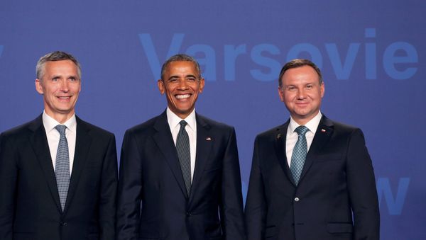 U.S. President Barack Obama (C) poses for a picture next to Poland's President Andrzej Duda (R) and NATO Secretary-General Jens Stoltenberg as he arrives at the NATO Summit at PGE National Stadium in Warsaw, Poland, July 8, 2016. U.S. President Barack Obama (C) poses for a picture next to Poland's President Andrzej Duda (R) and NATO Secretary-General Jens Stoltenberg as he arrives at the NATO Summit at PGE National Stadium in Warsaw, Poland, July 8, 2016. - Sputnik International