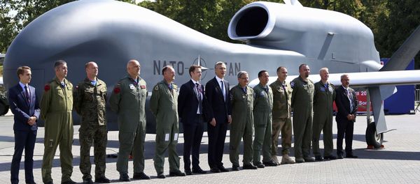 NATO Secretary-General Jens Stoltenberg (C) poses with officials and military personnel in front of a NATO unmanned drone outside PGE National Stadium, the venue of the NATO Summit, in Warsaw, Poland, July 8, 2016. NATO Secretary-General Jens Stoltenberg (C) poses with officials and military personnel in front of a NATO unmanned drone outside PGE National Stadium, the venue of the NATO Summit, in Warsaw, Poland, July 8, 2016. - Sputnik International