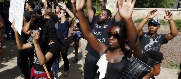 People march holding their hands in the air in protest as they walk through Smith Park in downtown Jackson, Miss., Friday afternoon, July 8, 2016. People march holding their hands in the air in protest as they walk through Smith Park in downtown Jackson, Miss., Friday afternoon, July 8, 2016. - Sputnik International