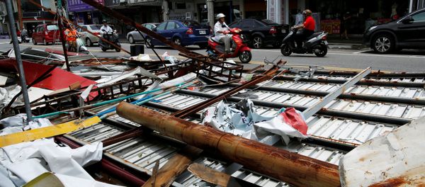 Motorcyclists ride past advertisement banners damaged by Typhoon Nepartak, in Taitung, Taiwan July 9, 2016 - Sputnik International