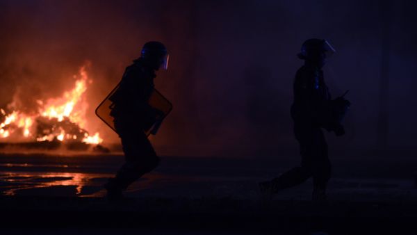 French riot police walk near a fire during the Euro 2016 final football match between Portugal and France at the Champ-de-Mars fan zone in Paris on July 10, 2016. Ronaldo's Portugal beat France 1-0 in Euro 2016 final. - Sputnik International