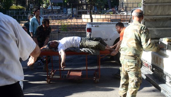 A wounded Syrian man is wheeled on a gurney into a hospital in the northern Syrian city of Aleppo (File) A wounded Syrian man is wheeled on a gurney into a hospital in the northern Syrian city of Aleppo (File) - Sputnik International