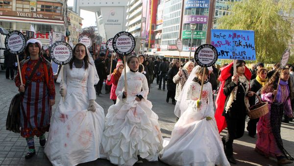 Women activists, some dressed in wedding gowns representing child brides forced into marriage, hold placards that read End violence to protest rape and domestic violence. - Sputnik International