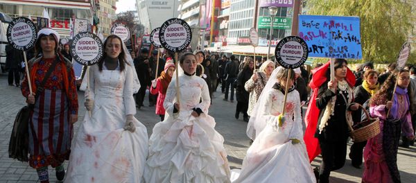 Women activists, some dressed in wedding gowns representing child brides forced into marriage, hold placards that read End violence to protest rape and domestic violence. - Sputnik International