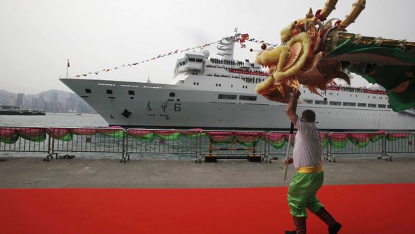 A man performs dragon dance as China's Yuanwang-6 space tracking ship is docked in Hong Kong's Victoria Harbor (File) A man performs dragon dance as China's Yuanwang-6 space tracking ship is docked in Hong Kong's Victoria Harbor (File) - Sputnik International