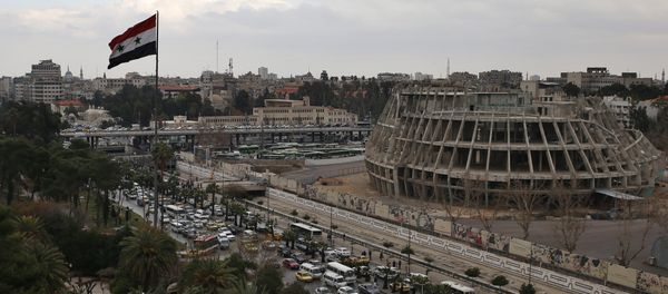 A Syrian national flag waves as vehicles move slowly in a traffic jam during rush hours on a road in Damascus , Syria (File) - Sputnik International