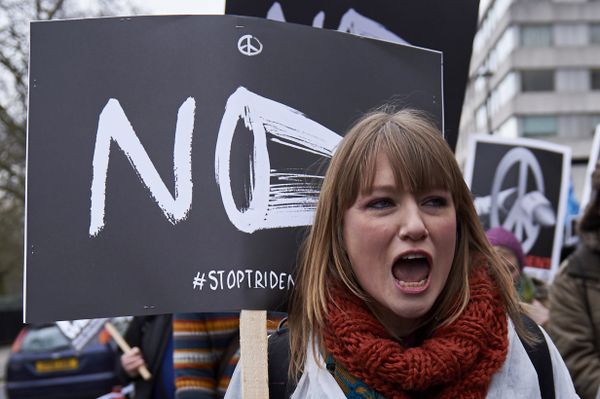 A protester shouts holding a placard as she marches in central London on February 27, 2016 in demonstration against a proposed renewal of Britain's Trident nuclear weapon system. - Sputnik International
