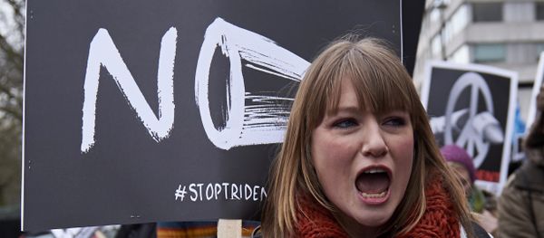 A protester shouts holding a placard as she marches in central London on February 27, 2016 in demonstration against a proposed renewal of Britain's Trident nuclear weapon system. A protester shouts holding a placard as she marches in central London on February 27, 2016 in demonstration against a proposed renewal of Britain's Trident nuclear weapon system. - Sputnik International