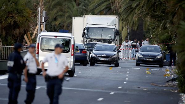 French police continue their investigation as they work near the heavy truck that ran into a crowd at high speed celebrating the Bastille Day July 14 national holiday on the Promenade des Anglais killing 80 people in Nice, France, July 15, 2016. - Sputnik International