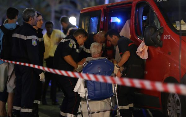 Rescue workers help an injured woman to get in a ambulance on July 15, 2016, after a truck drove into a crowd watching a fireworks display in the French Riviera town of Nice. Rescue workers help an injured woman to get in a ambulance on July 15, 2016, after a truck drove into a crowd watching a fireworks display in the French Riviera town of Nice. - Sputnik International