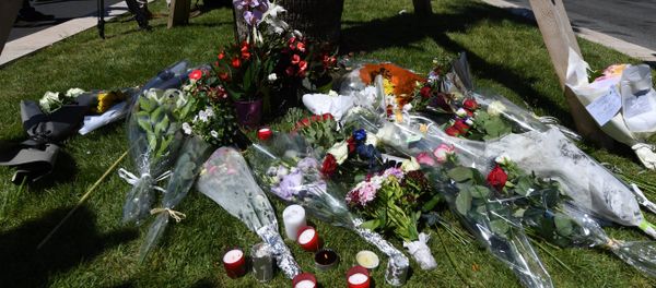 A photo taken on July 15, 2016 shows flowers and candles placed near the site in Nice where a gunman smashed a truck into a crowd of revellers celebrating Bastille Day, killing at least 84 people. - Sputnik International