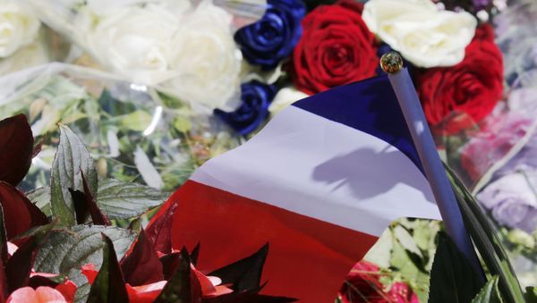 A bouquet of flowers and a French flag is seen as people pay tribute near the scene where a truck ran into a crowd at high speed killing scores and injuring more who were celebrating the Bastille Day national holiday, in Nice, France, July 15, 2016. A bouquet of flowers and a French flag is seen as people pay tribute near the scene where a truck ran into a crowd at high speed killing scores and injuring more who were celebrating the Bastille Day national holiday, in Nice, France, July 15, 2016. - Sputnik International