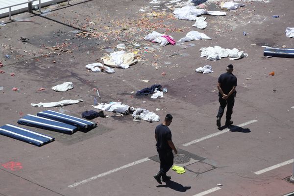 French gendarmes walk past clothes and mattresses at the site of the deadly attack on the Promenade des Anglais seafront in the French Riviera city of Nice on July 15, 2016, after a gunman smashed a truck through a crowd celebrating Bastille Day, killing at least 84 and injuring dozens French gendarmes walk past clothes and mattresses at the site of the deadly attack on the Promenade des Anglais seafront in the French Riviera city of Nice on July 15, 2016, after a gunman smashed a truck through a crowd celebrating Bastille Day, killing at least 84 and injuring dozens - Sputnik International