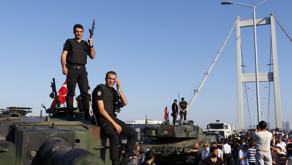 Policemen stand atop military armored vehicles after troops involved in the coup surrendered on the Bosphorus Bridge in Istanbul, Turkey July 16, 2016. - Sputnik International